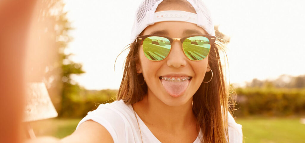 Teenage girl happy with the benefits of brushing her tongue