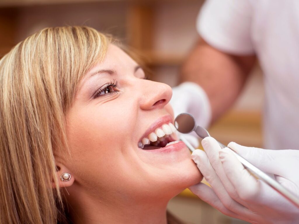 woman getting dental cleanings with braces