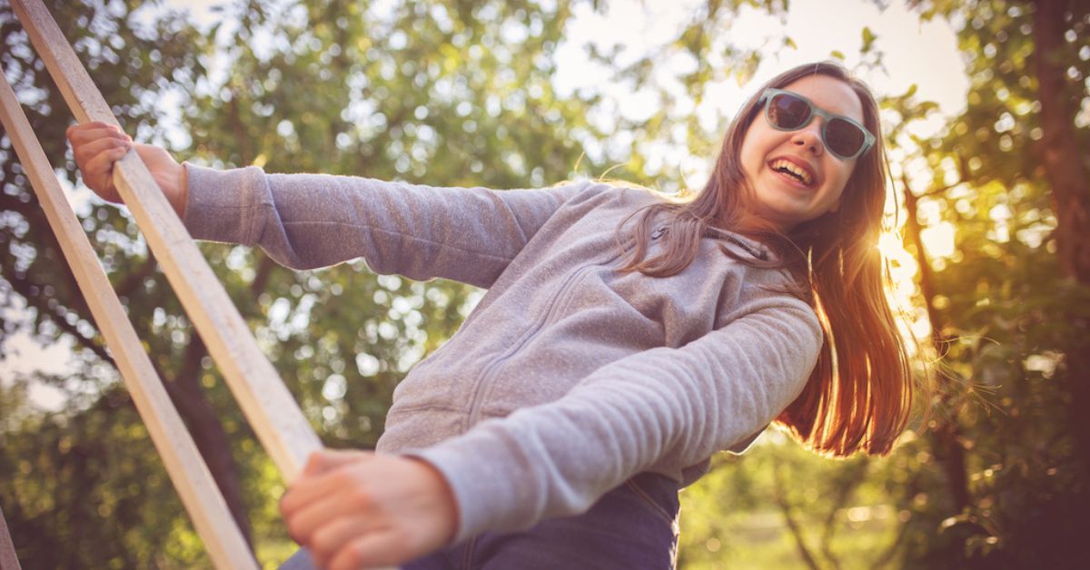 teen climbs ladder after cleaning retainer