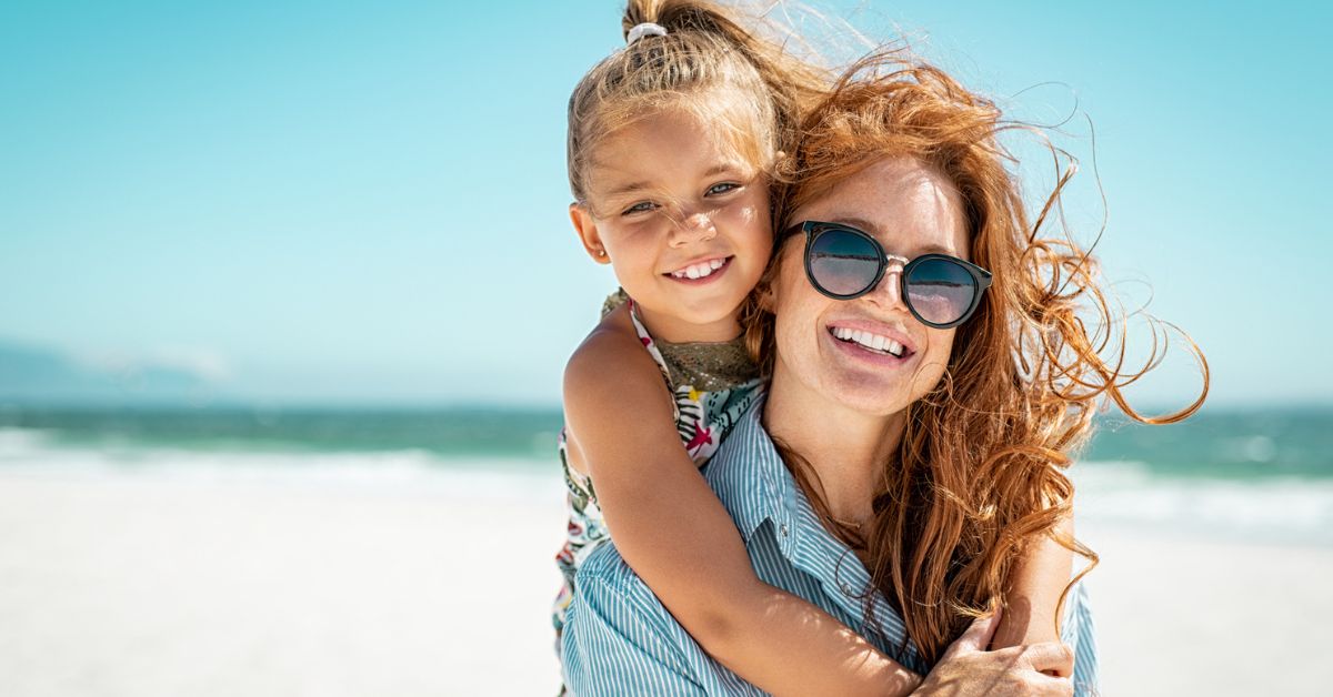 mother and daughter on the beach talk Braces at age 7