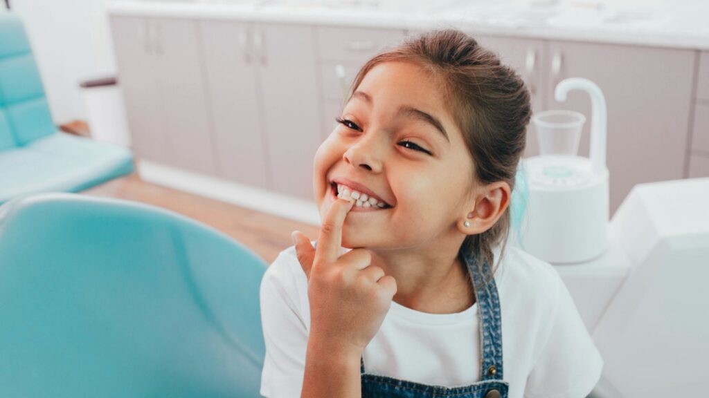 Young girl smiling in orthodontic chair at Insoft & Hurst Orthodontics, Seminole FL.